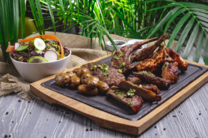 Tanzania local foods – Nyama choma grilled and served on a traditional wooden plate